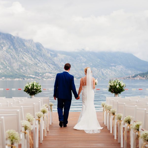 wedding couple at destination wedding ceremony. Mountains and sea view in Montenegro. Picturesque wedding location.